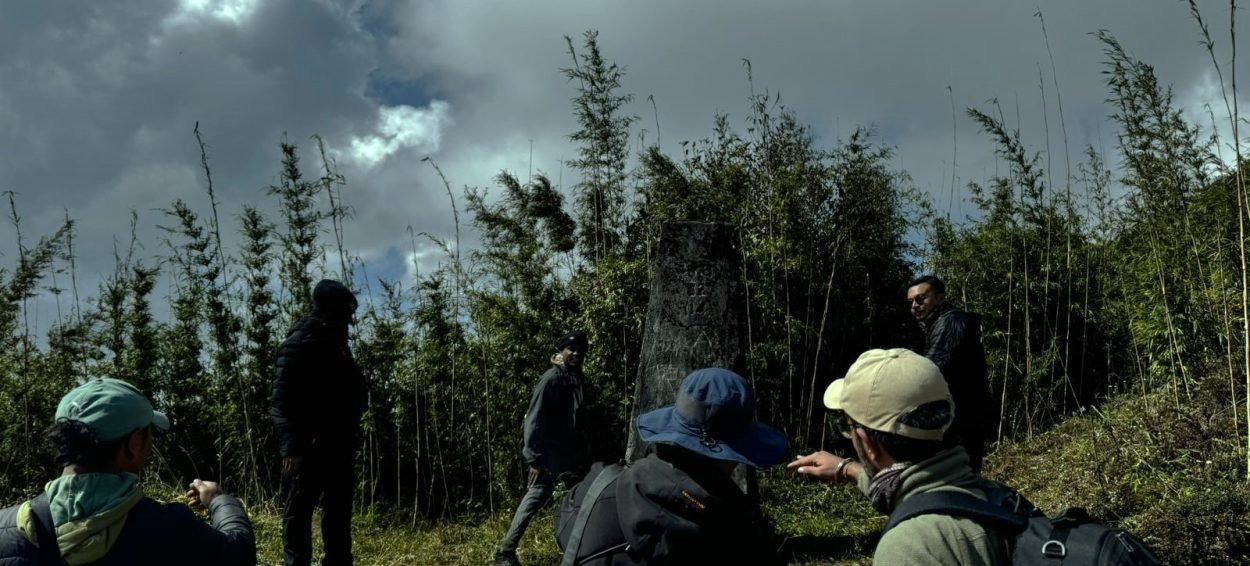 Red panda expedition team in Singalila National Park's dense forest, observing wildlife in lush greenery